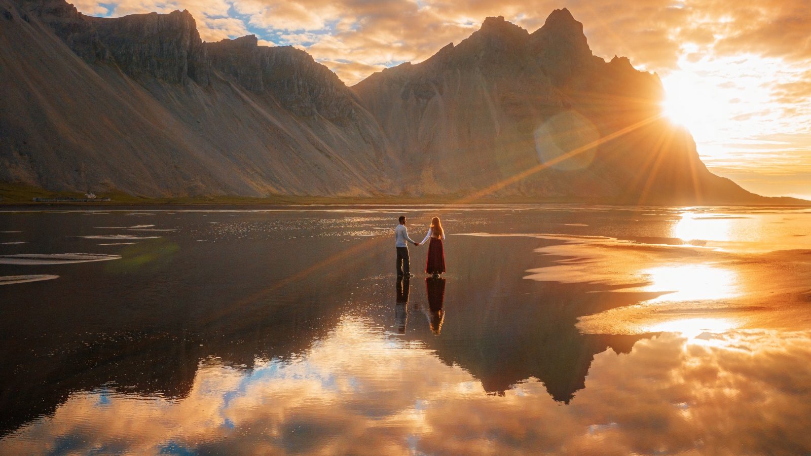 couple at sunrise at Stokksness in Iceland