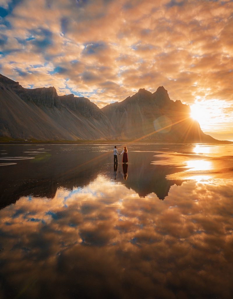 couple at sunrise at Stokksness in Iceland