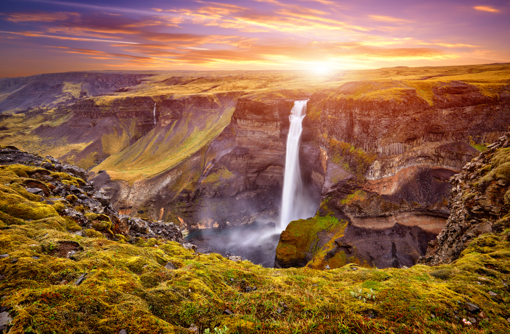 Haifoss waterfall at sunset with green around it during your 4 days in Iceland