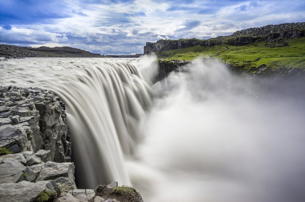 A wide, powerful waterfall with a cloud of billowing mist.