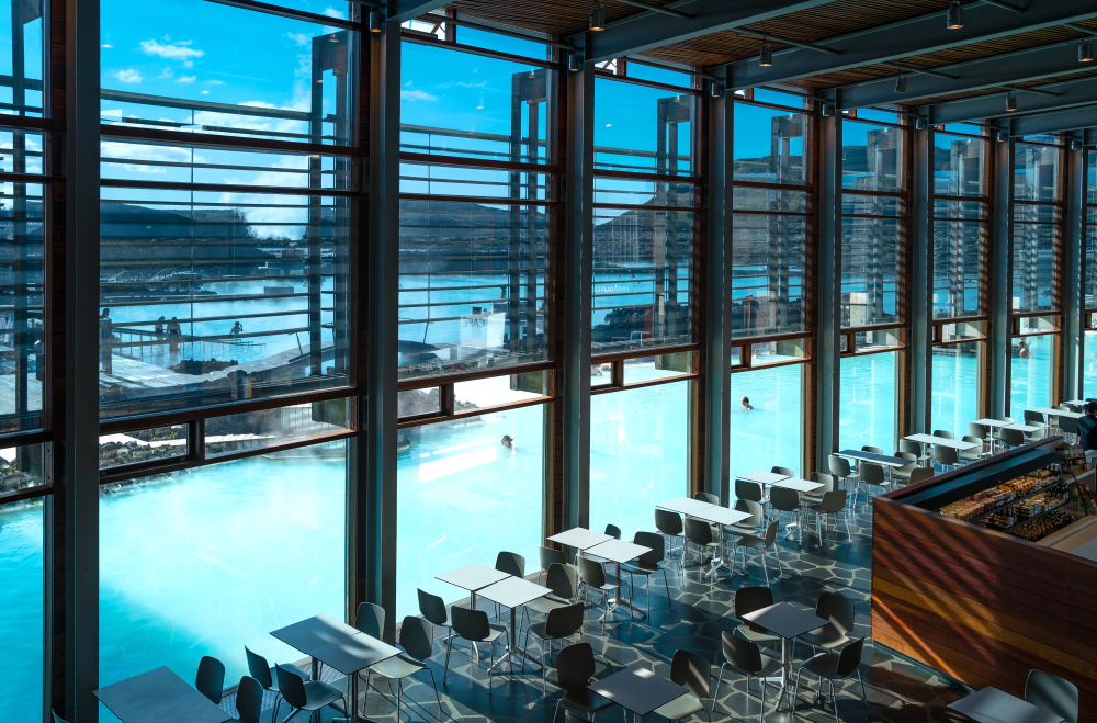 tables and chairs inside Lava Restaurant with views of the Blue lagoon outside