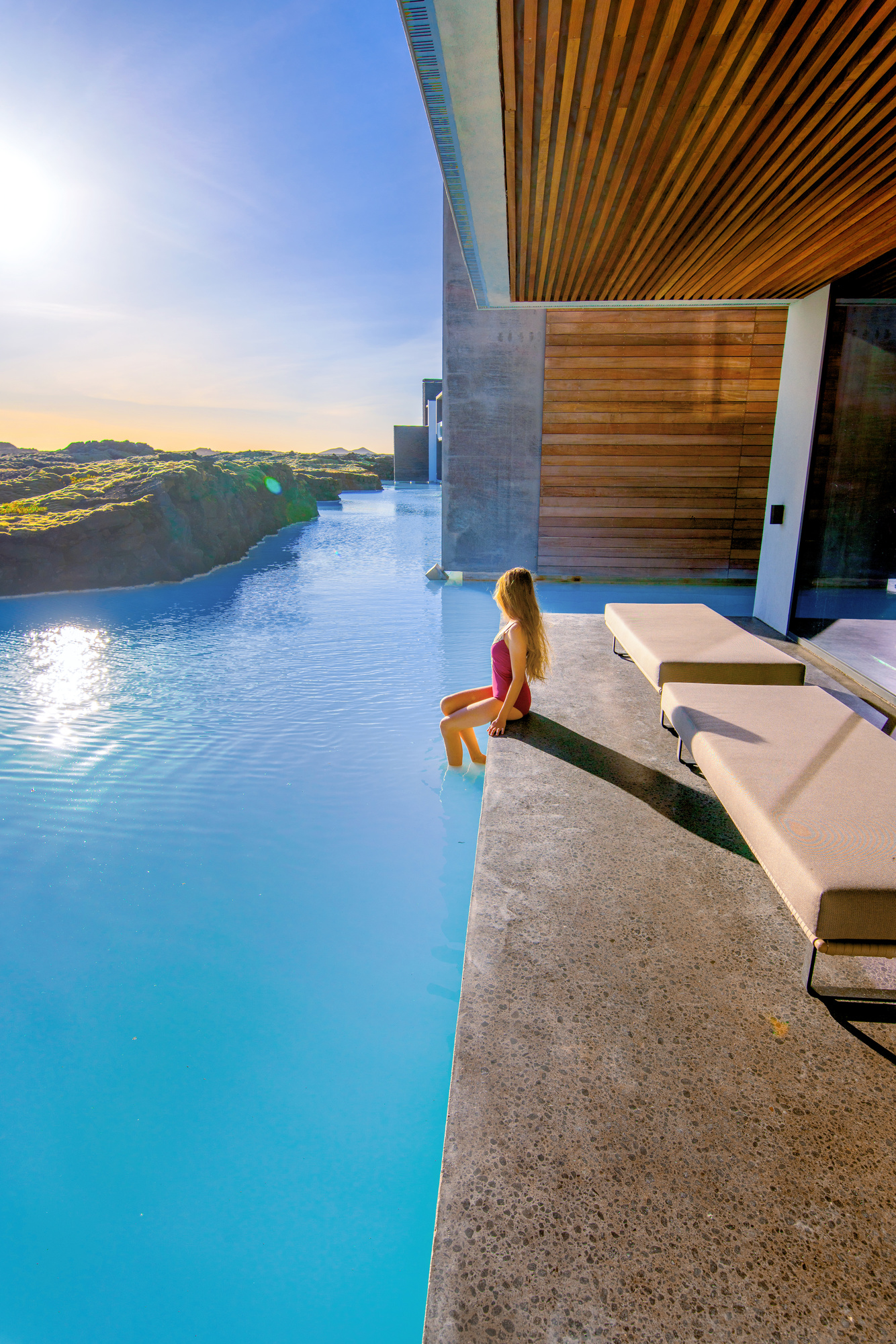 Woman sitting on ledge near the Blue Lagoon Iceland