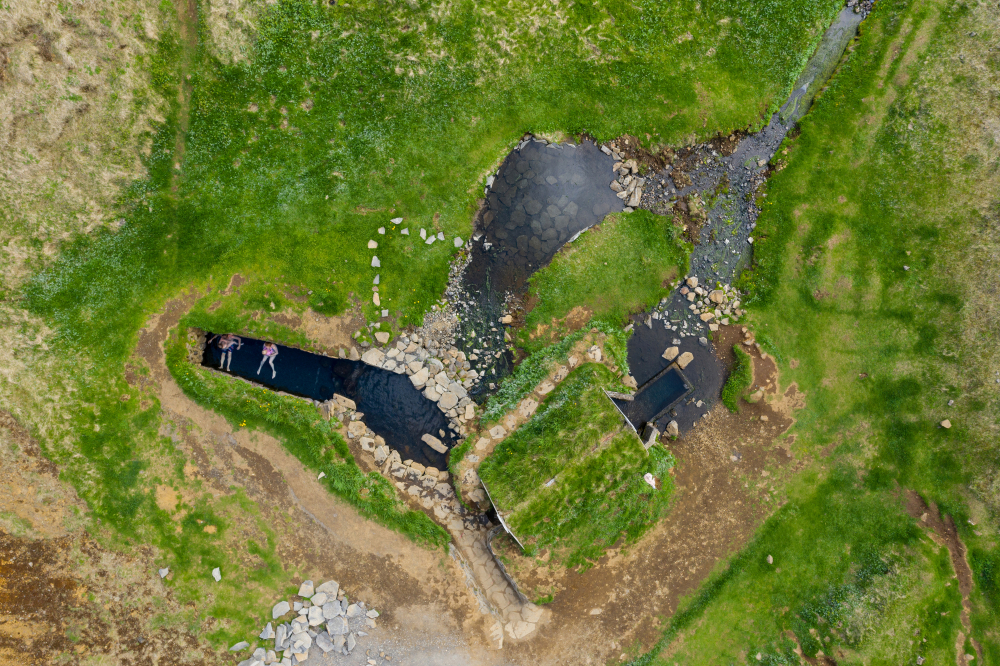 drone view of Hrunalaug hot springs in Iceland