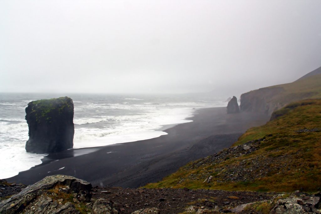 rock formations along black sand beach Iceland Itinerary