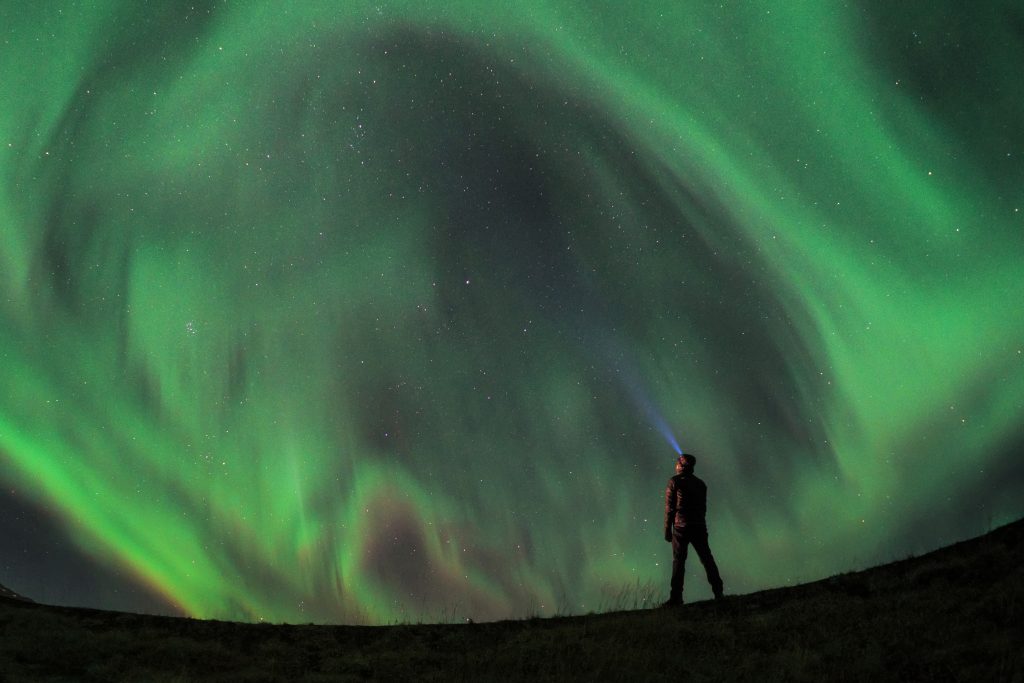 Man standing in front of Northern Lights