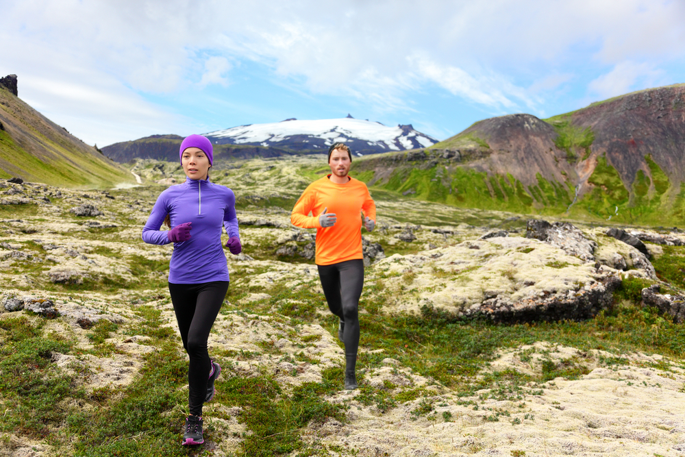 Photo of couple running in Snaefellsnes Iceland, one of the three national parks.