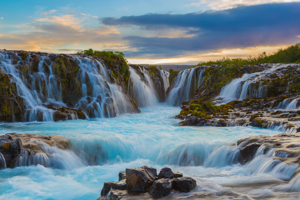 multiple waterfalls flowing into a raging river