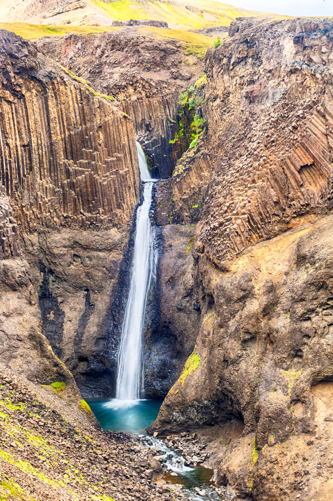 Litlanesfoss waterfall surrounded by long Basalt columns