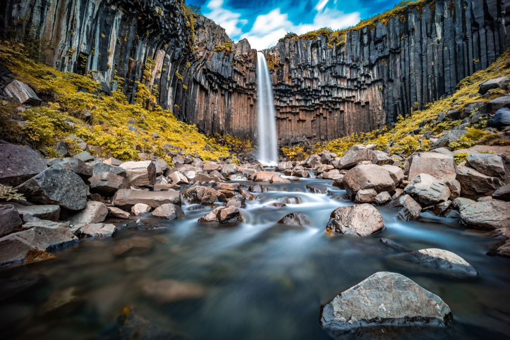 The impressive Svartifoss waterfall in Iceland surrounded by basalt columns 