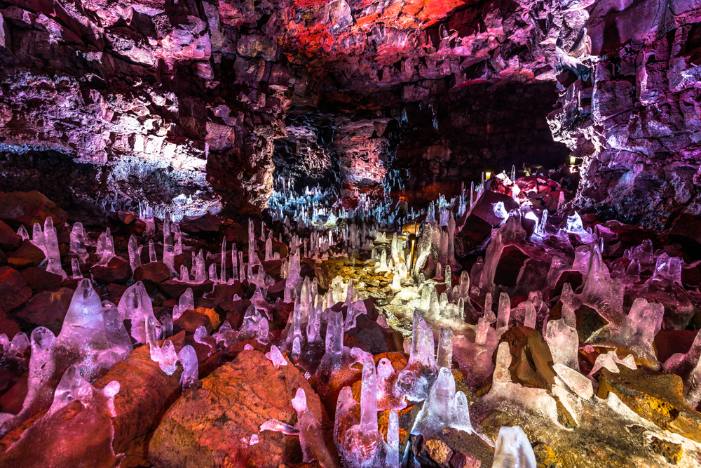 a myriad of different colored rock formations and sediment in a cave
