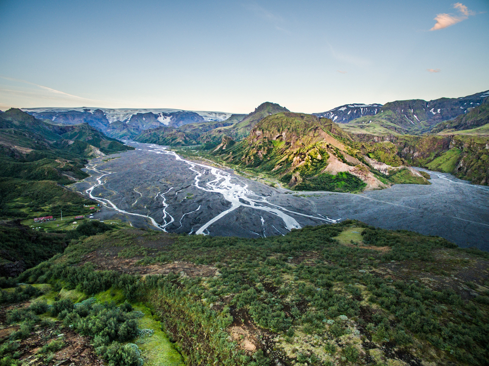 above view of thorsmork in iceland with winding rivers below and mountains in the distance