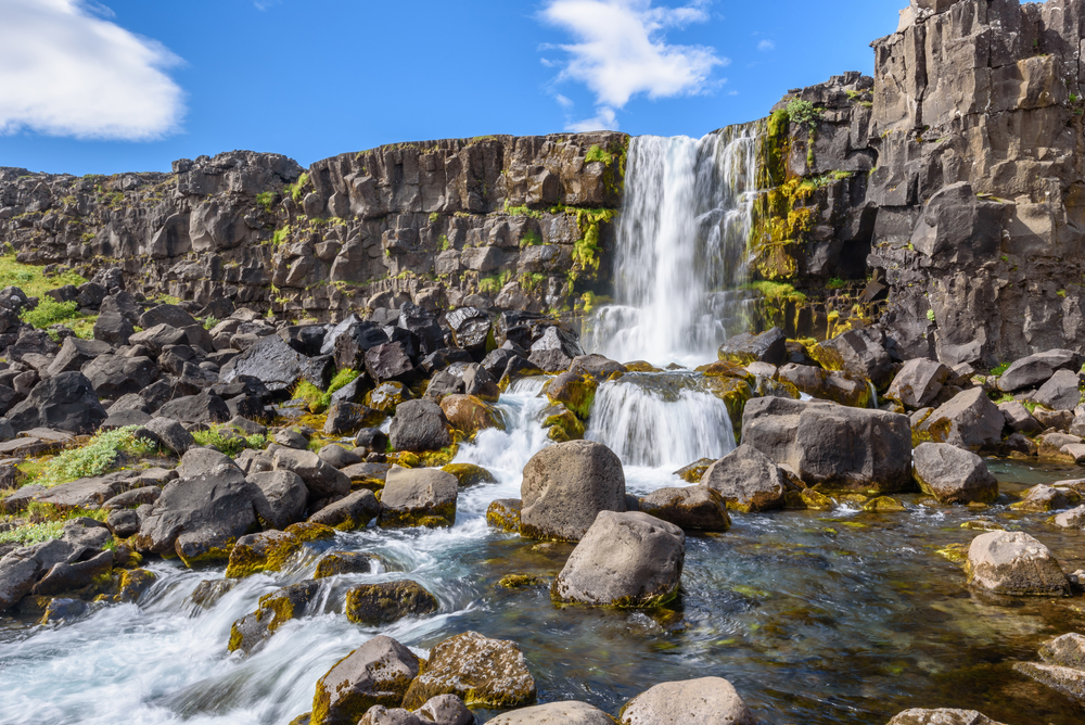 small waterfall at Thingvellir National park on a sunny day