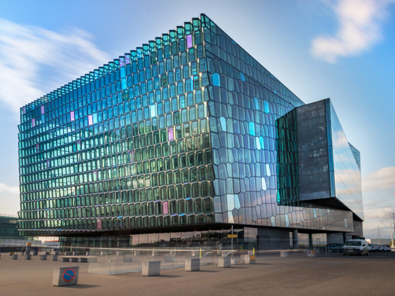 The Harpa center in Reykjavik with its many windows and boxy architectural design. 