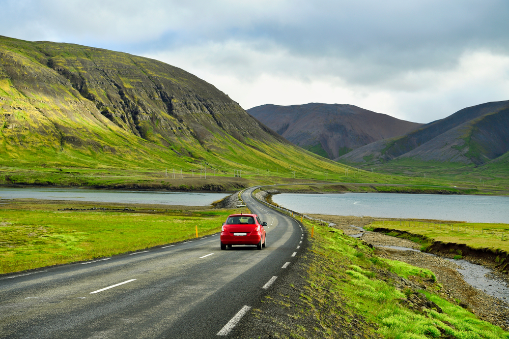 Photo of a car driving in Iceland.