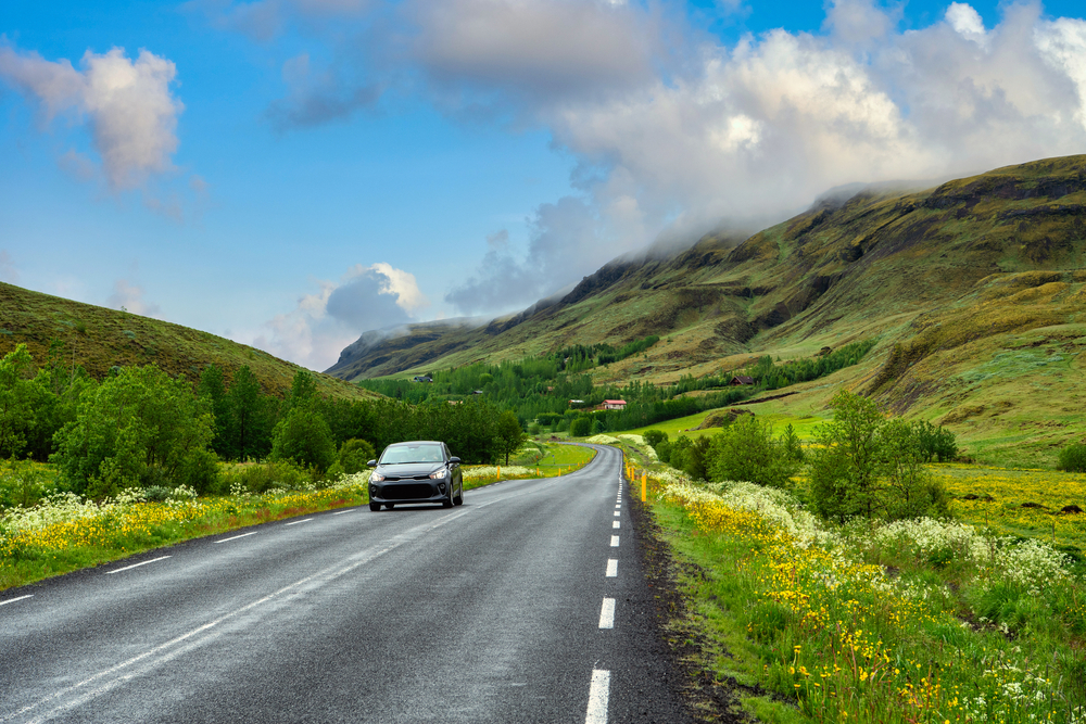 Photo of a car driving in Iceland.