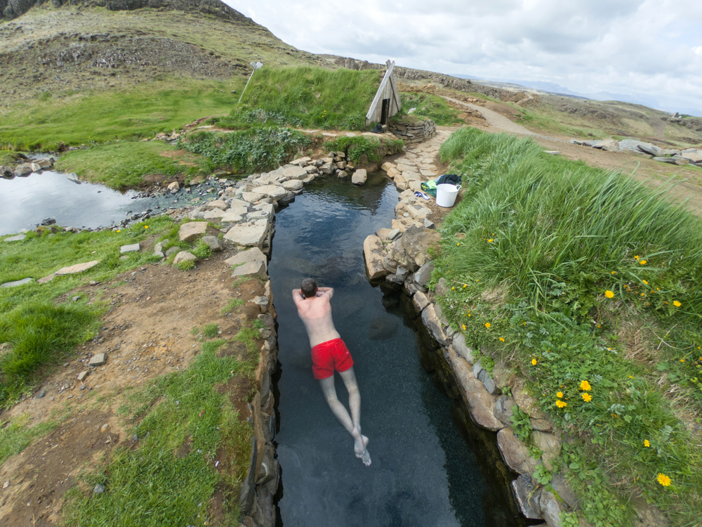 man in third and hottest pool at hrunalaug hot springs