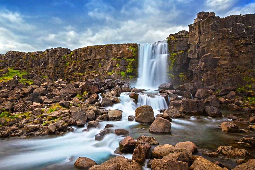 a nice waterfall surrounded by basalt and moss