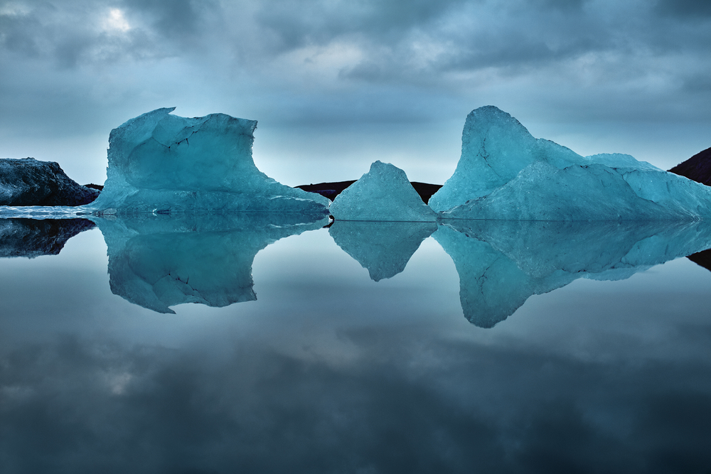 icebergs and their reflections at jokulsarlon glacier lagoon