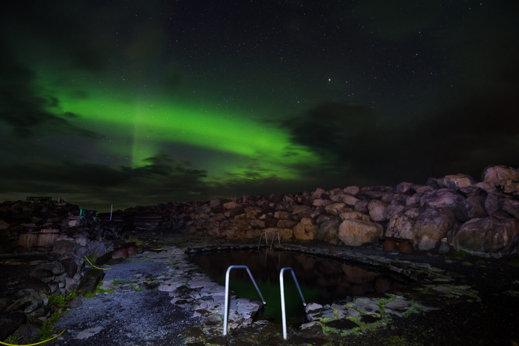 northern lights over grettislaug hot springs north iceland