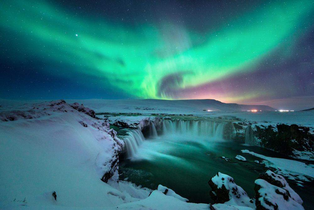 northern lights in Iceland over godafoss