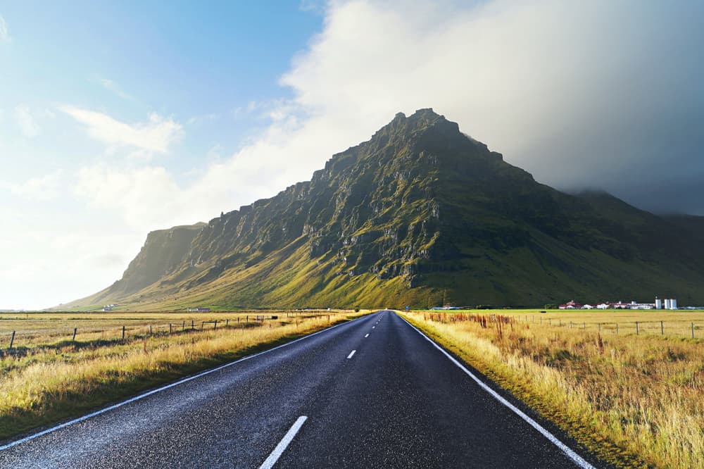 road in iceland with green hills