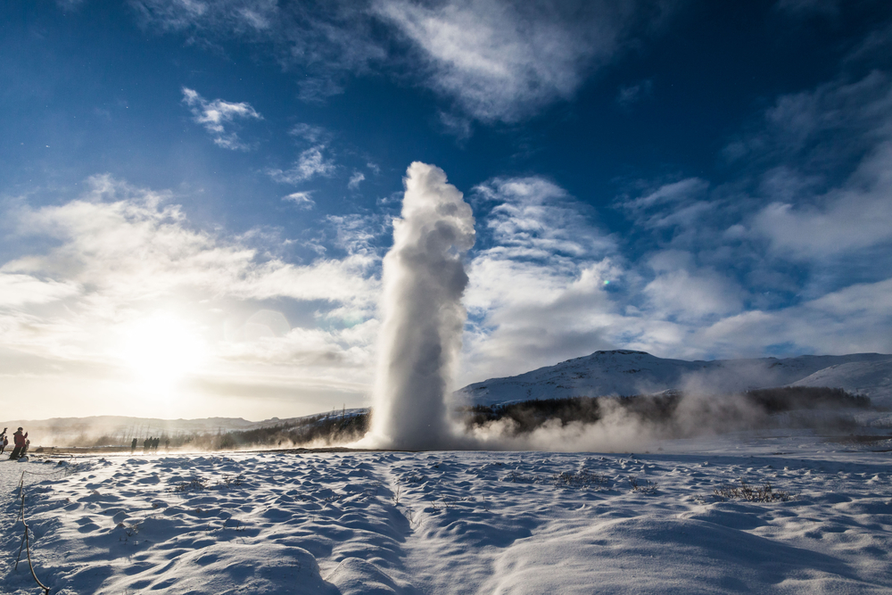 a Geysir blasting water into the sky in Iceland in the winter 