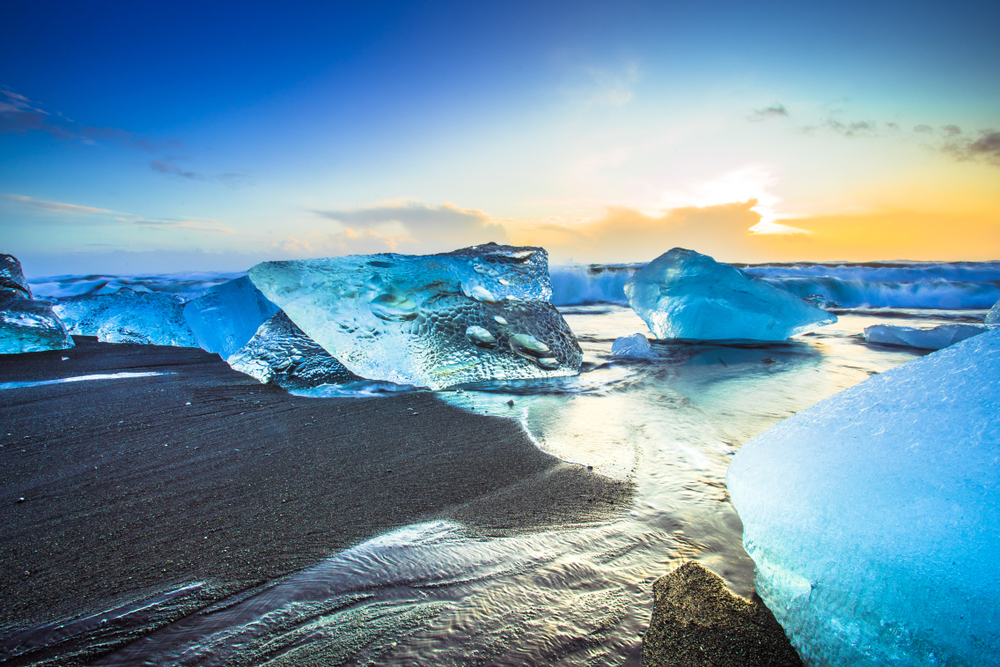 Low angle shot of ice on Diamond Beach at sunset.