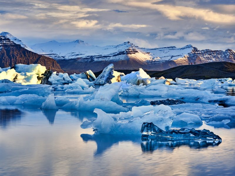 Dusk at Jokulsarlon Glacier Lagoon with mountains in the distance.