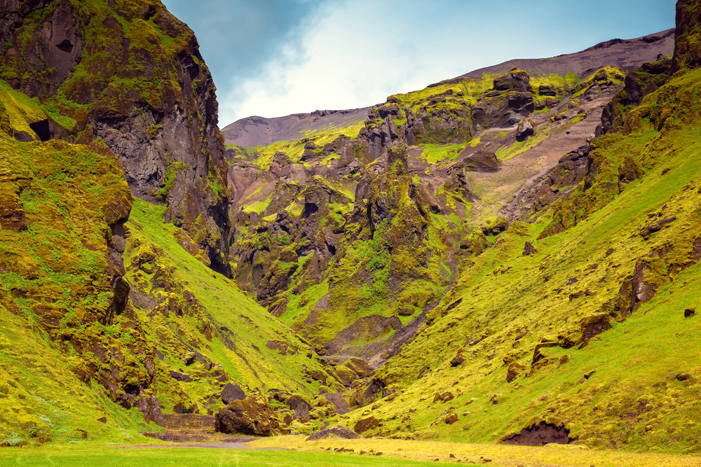 The green and brown walls of Þakgil Canyon.