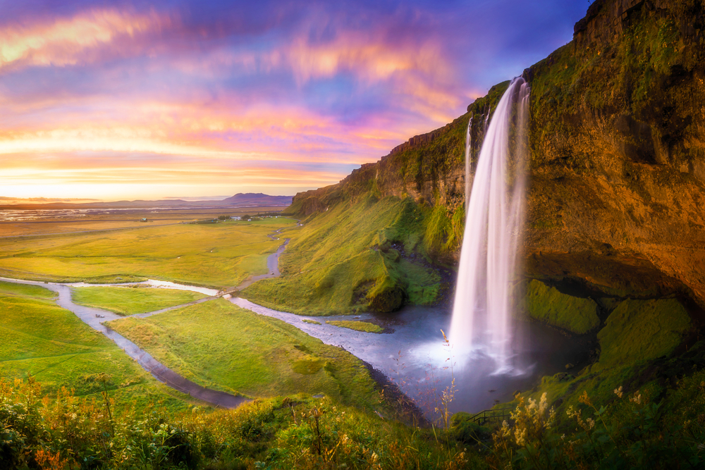 Side view of Seljalandsfoss Waterfall at sunset.