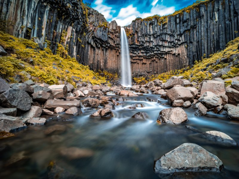 Svartifoss Waterfall cascading down among basalt columns.