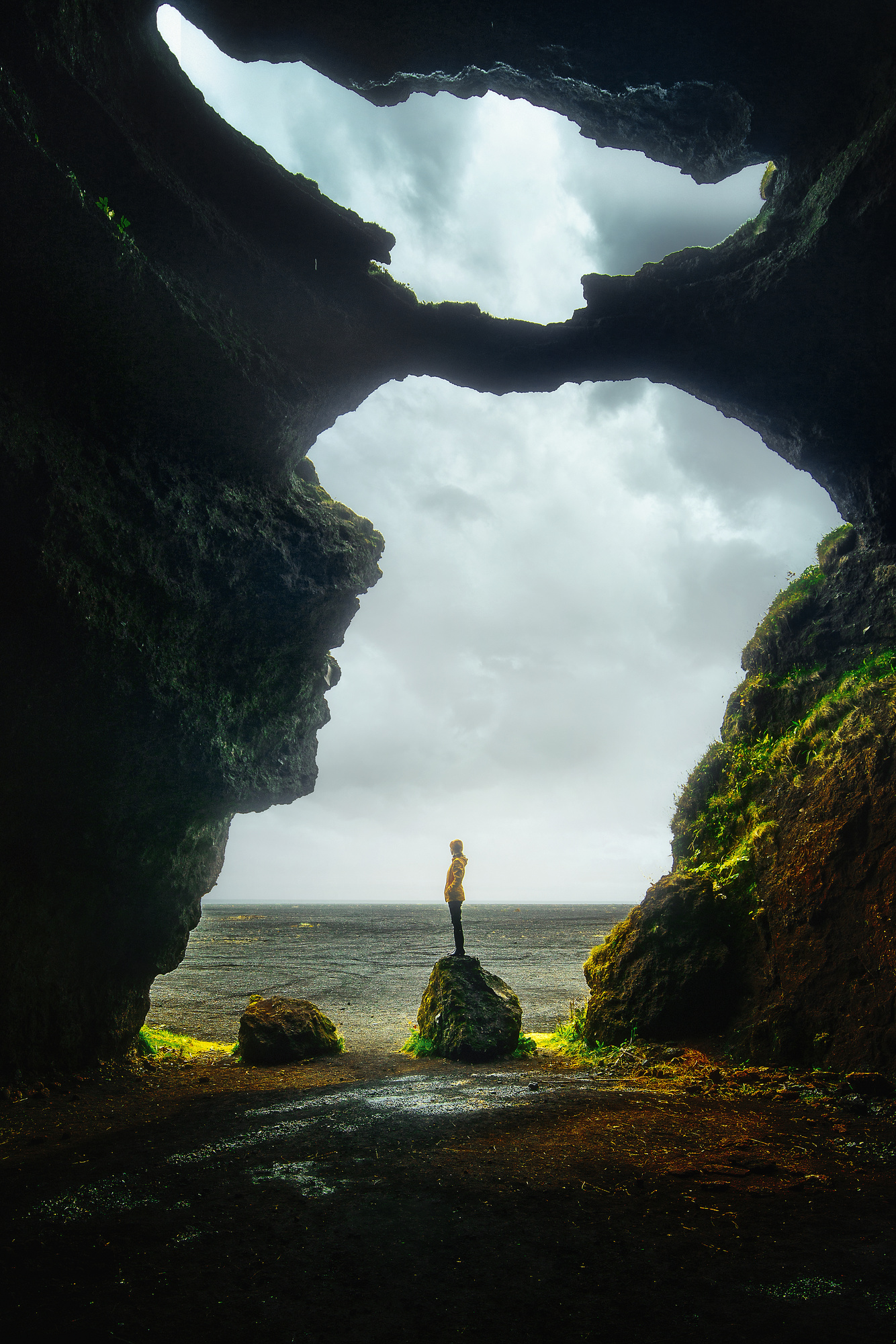 Figure standing in opening of Yoda Cave during 5 days in Iceland