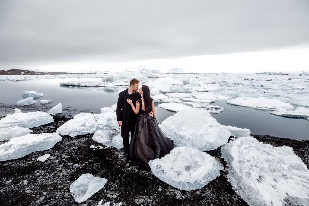 couple gazing at each other on the shores of a glacier lagoon Iceland wedding