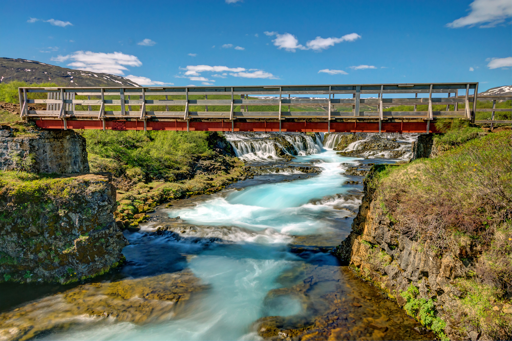 A footbridge over the river in front of Bruarfoss.