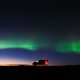 campervan in iceland with the northern lights behind it