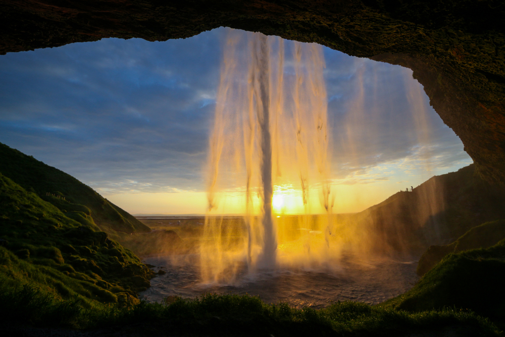 behind Seljalandsfoss Waterfall at sunset on a 3 day trip to iceland