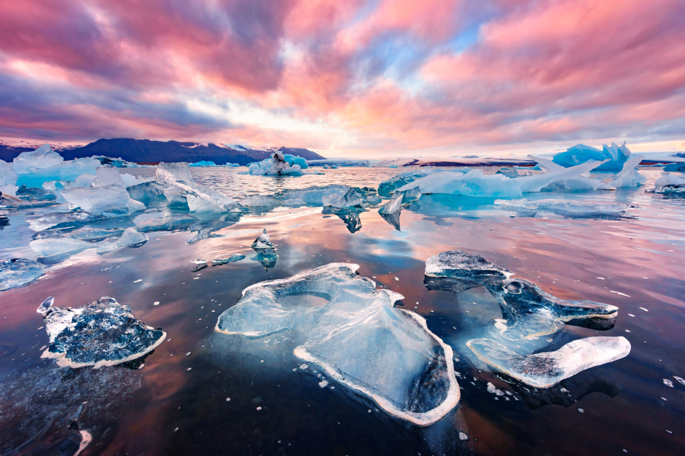 glacial lagoon in iceland at sunset with ice chunks