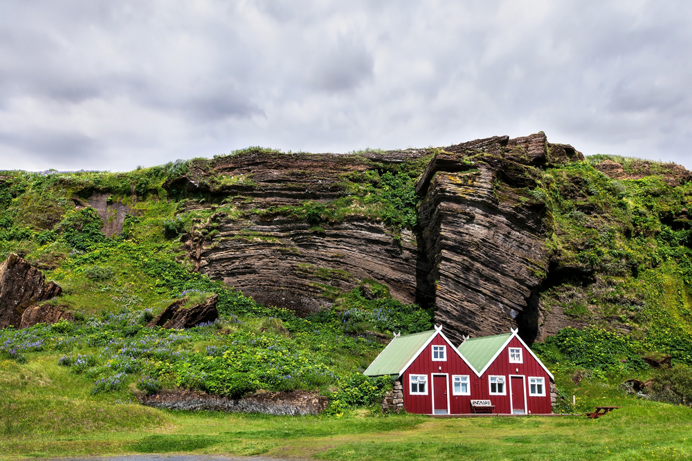 small red cabins in iceland on a sunny day for a stop on a 3 day Iceland itinerary