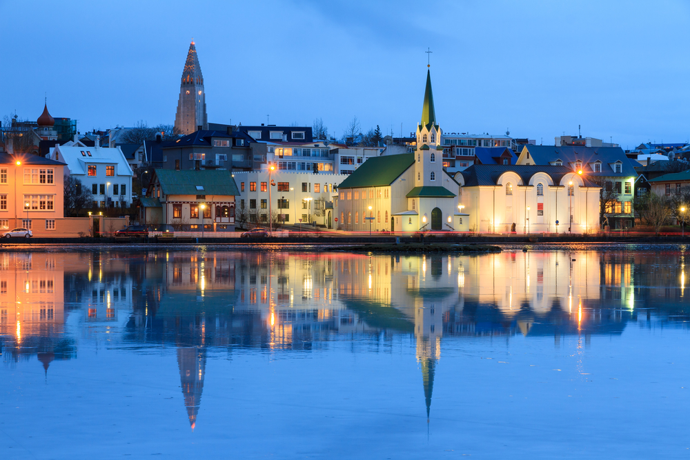 reykjavik at night with water reflection of city as part of a 3 days in Iceland itinerary