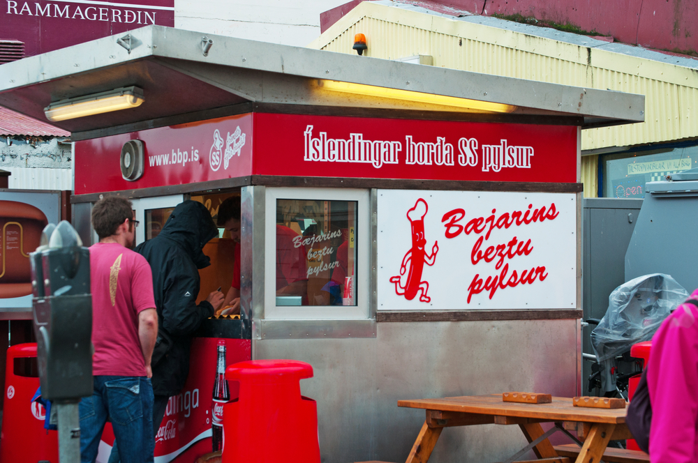 People waiting in line to get hot dogs with an Icelandic twist at the famous Baejarins Beztu Pylsur stand in Reykjavik