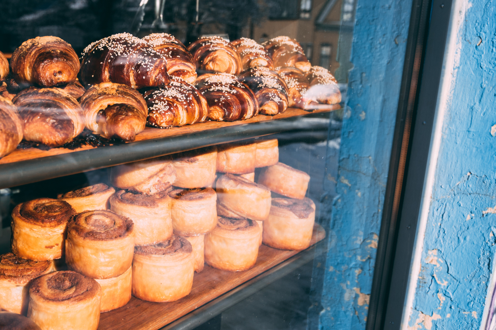 Cinnamon rolls and croissants in the window of the bakery Braud and Co. 