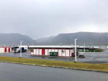one of the gas stations in iceland on a moody day with clouds the building is red and white