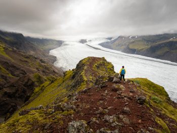 person after one of the hikes in iceland overlooking a glacier
