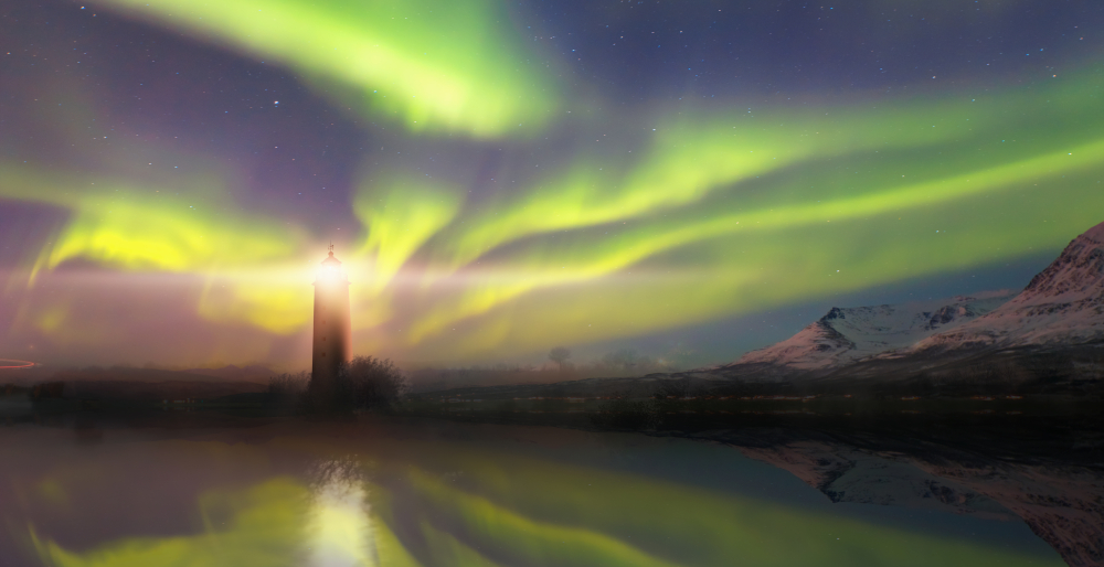 the Northern Lights swirling above the Grotta lighthouse