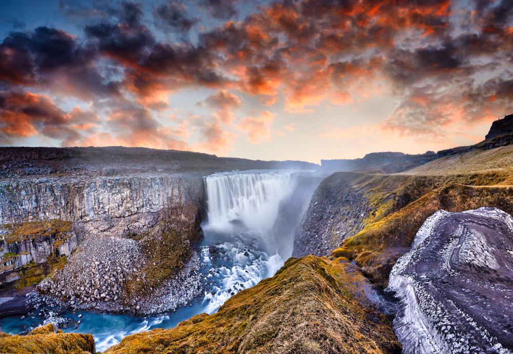 raging Dettifoss Waterfall flowing in Jokulsargljufur Canyon at sunset