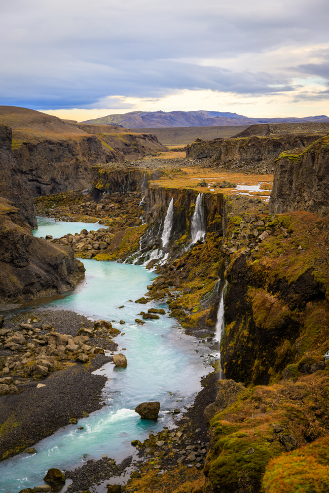 Iceland Canyon Sigoldugljufur Canyon with multiple waterfalls flowing into a glacial river