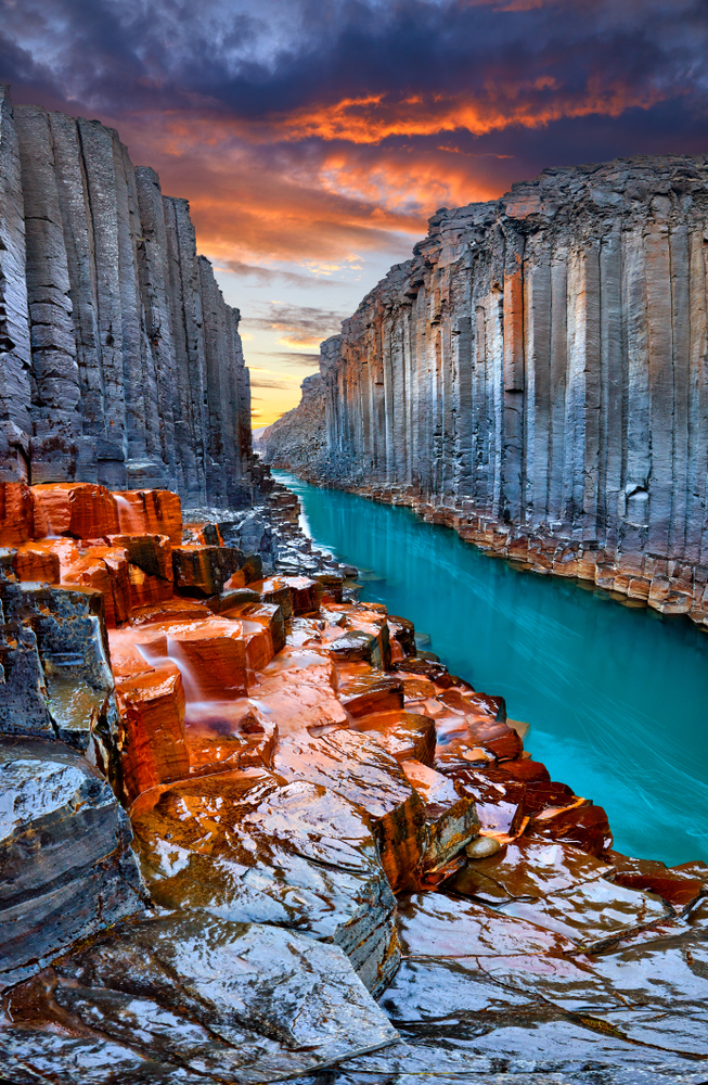 Iceland Canyon Studlagil Basalt Canyon with colorful stone and blue river | basalt canyon in Iceland with glacier river