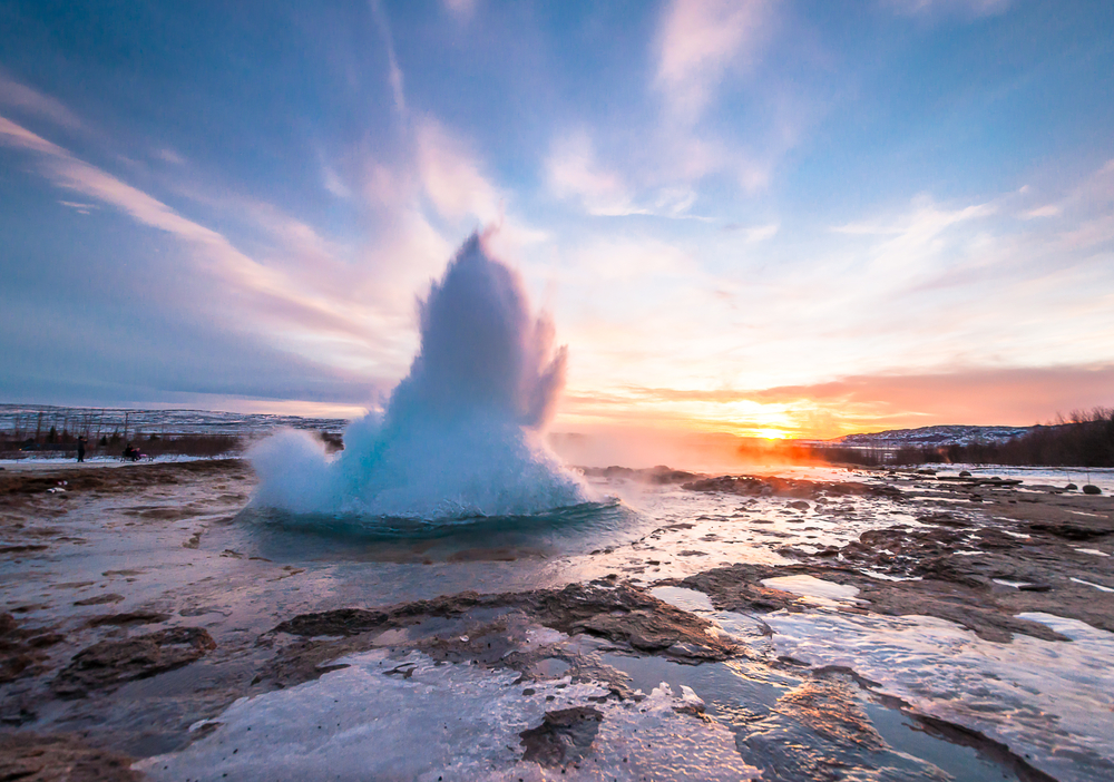 Strokkur erupting at sunset.