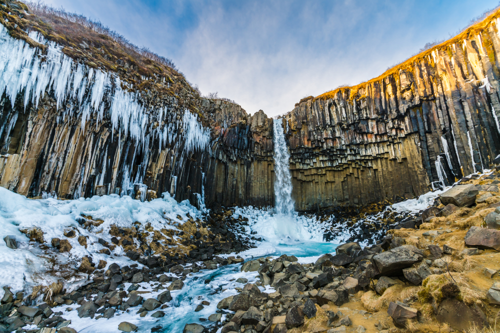 Svartifoss Waterfall surrounded by black basalt columns and icicles.