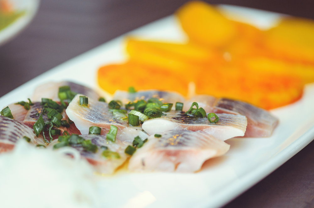 Pieces of fish and onions on a plate